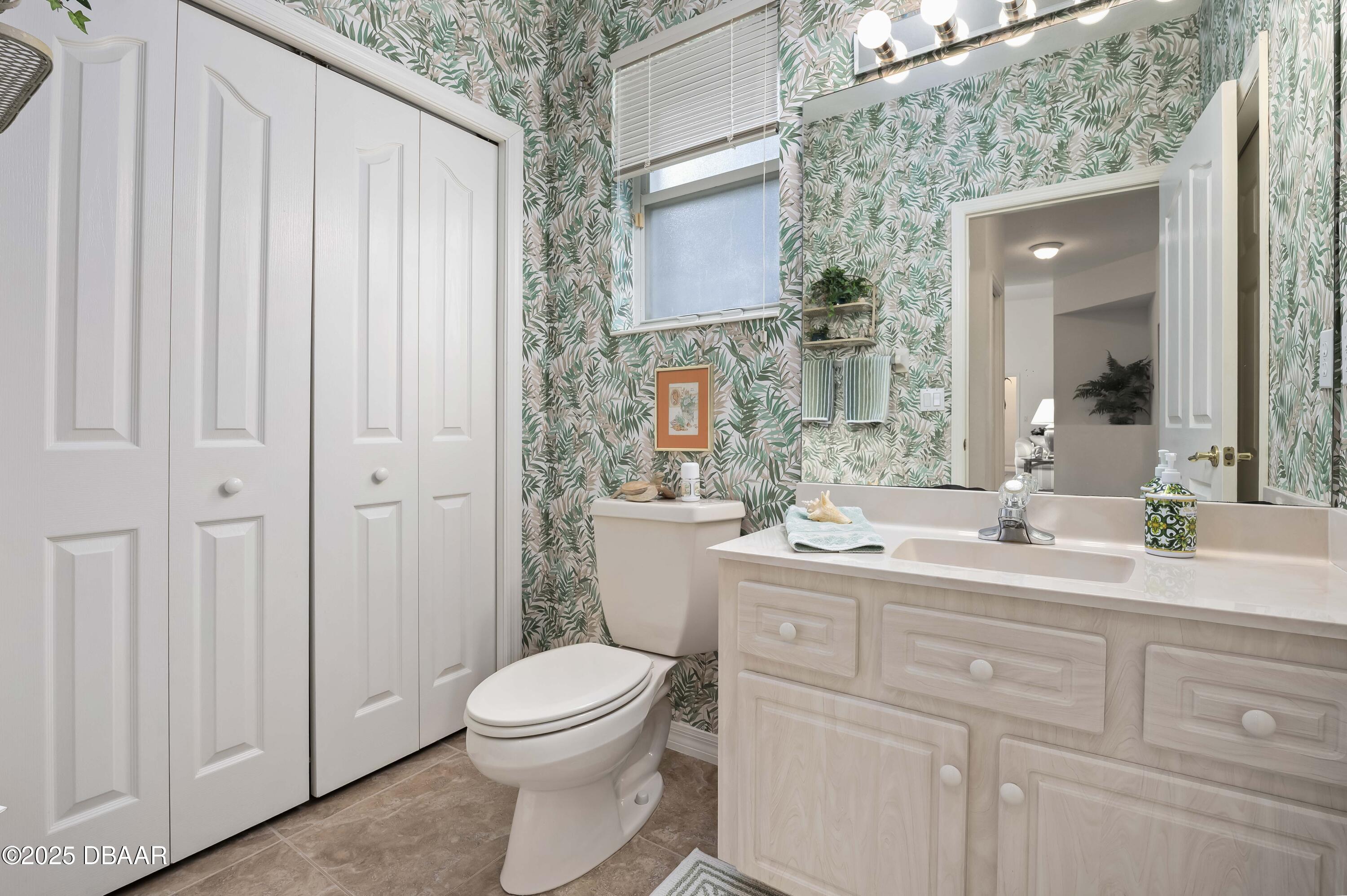 38 South Turn Circle Ponce Inlet, FL 32127 - Photo 24 of 49 a spacious bathroom with a granite countertop sink a toilet and a mirror