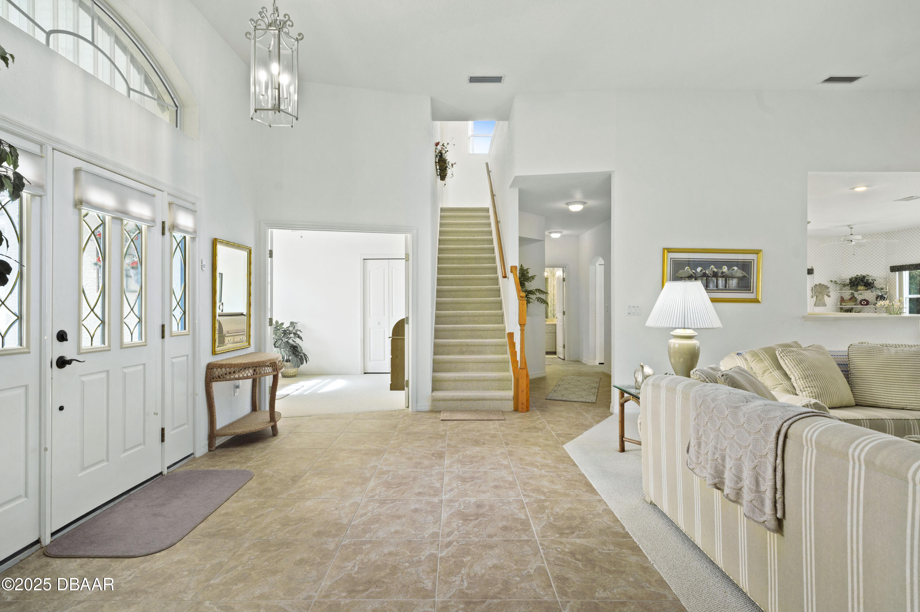 38 South Turn Circle Ponce Inlet, FL 32127 - Photo 25 of 49 a living room with furniture and a chandelier