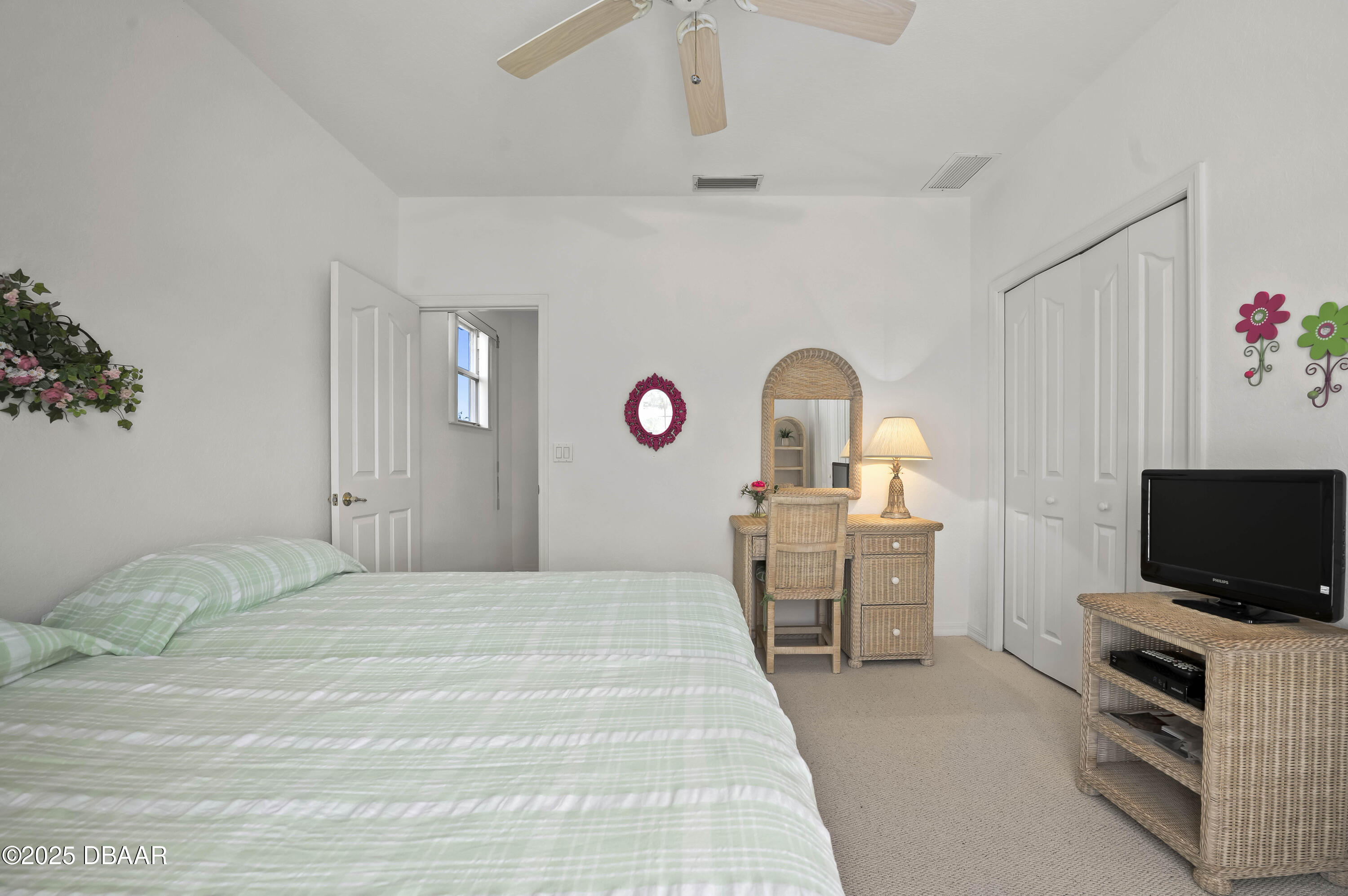 38 South Turn Circle Ponce Inlet, FL 32127 - Photo 27 of 49 a bedroom with a bed and a flat screen tv