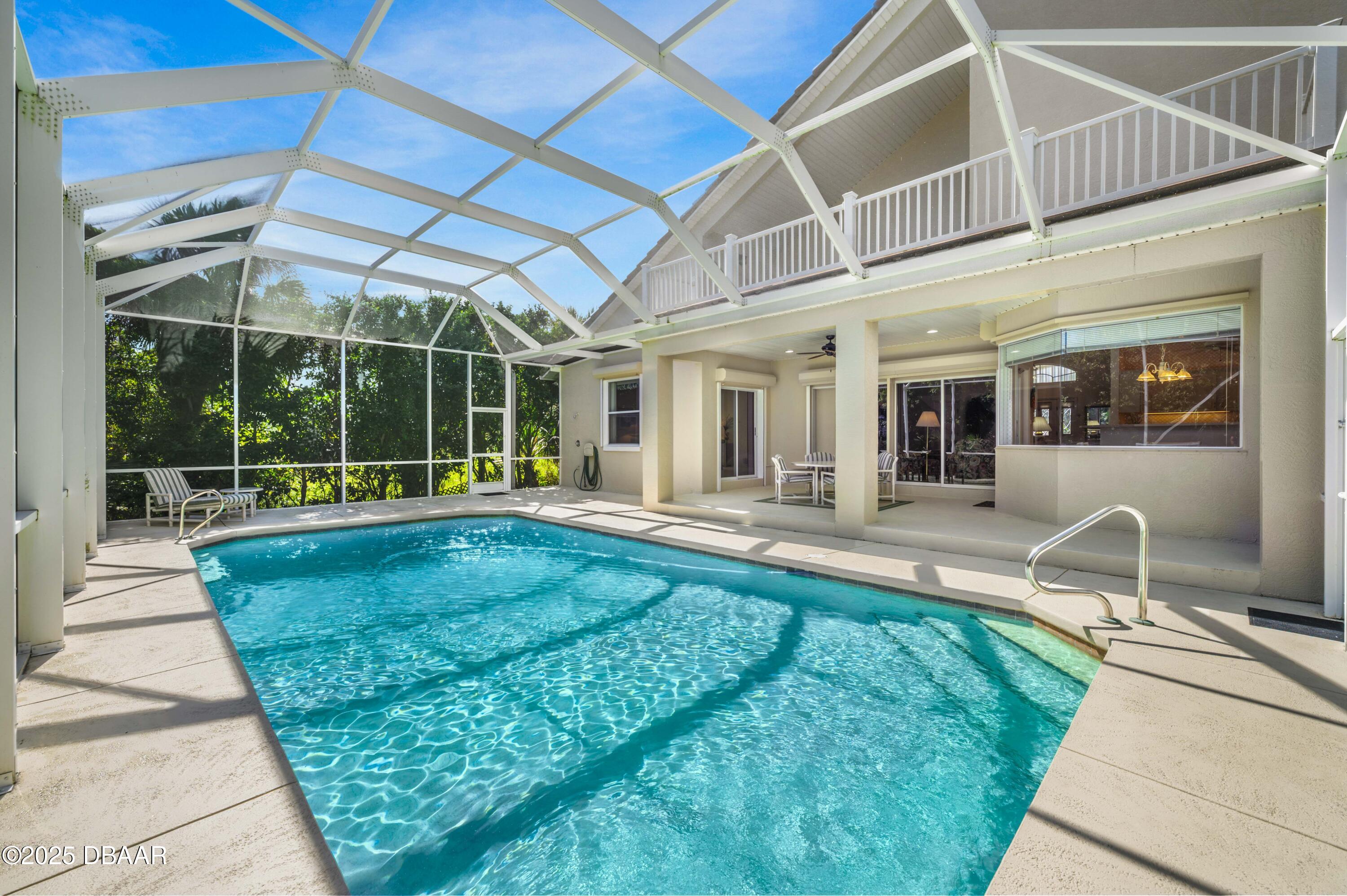 38 South Turn Circle Ponce Inlet, FL 32127 - Photo 35 of 49 a view of a patio with a table and chairs under an umbrella
