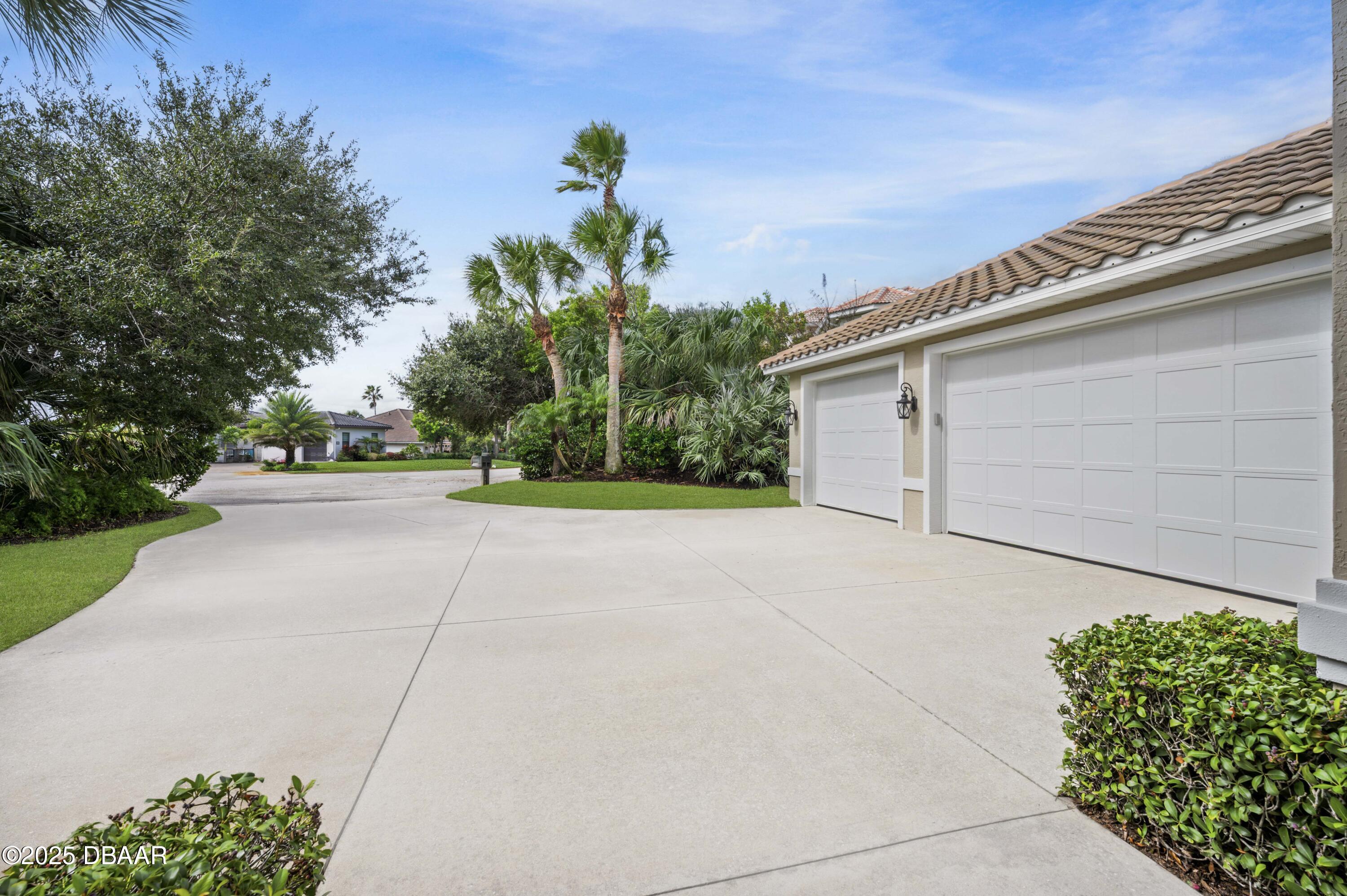 38 South Turn Circle Ponce Inlet, FL 32127 - Photo 40 of 49 a house view with a garden space