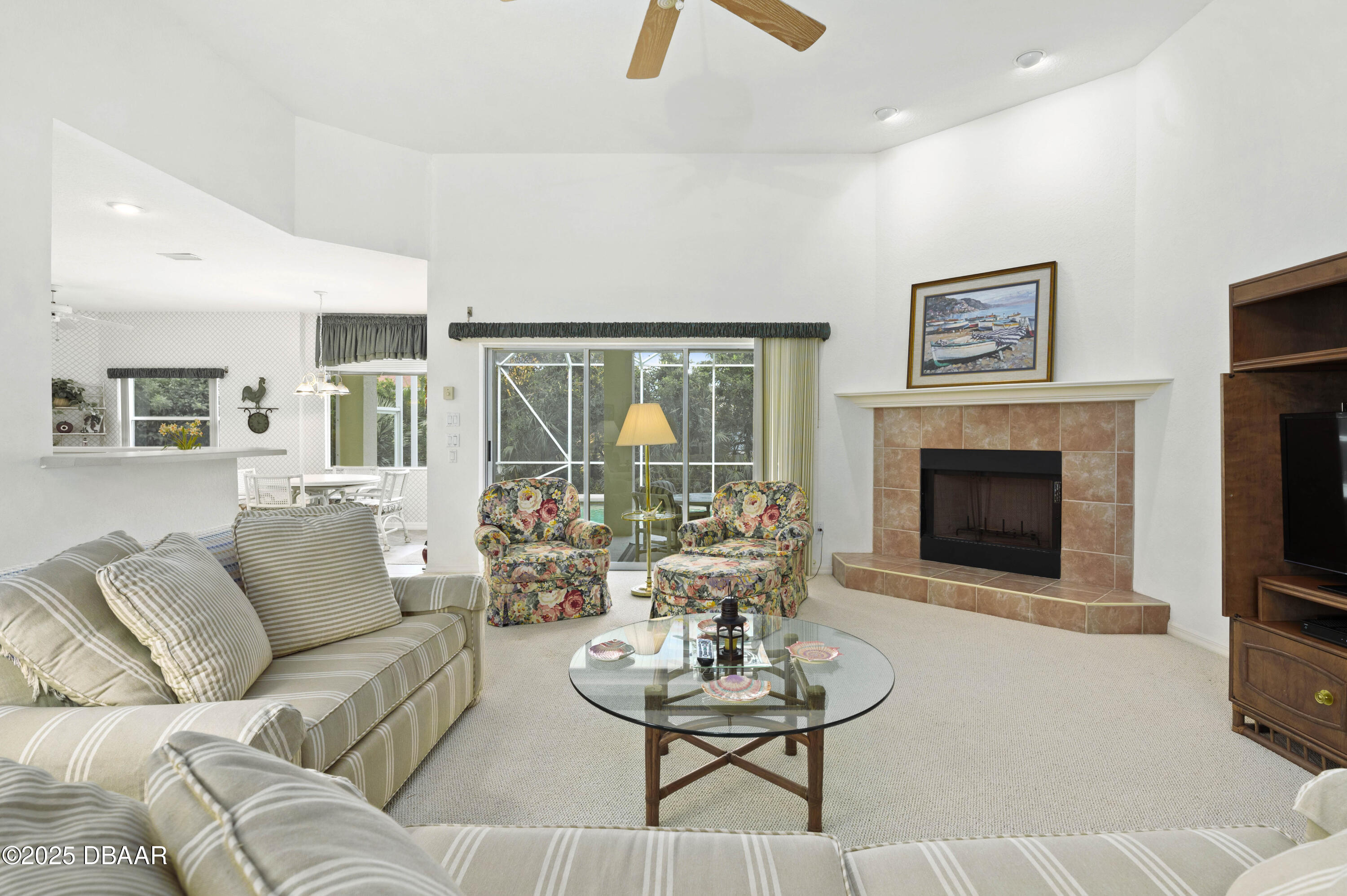 38 South Turn Circle Ponce Inlet, FL 32127 - Photo 5 of 49 a living room with furniture a fireplace and a large window