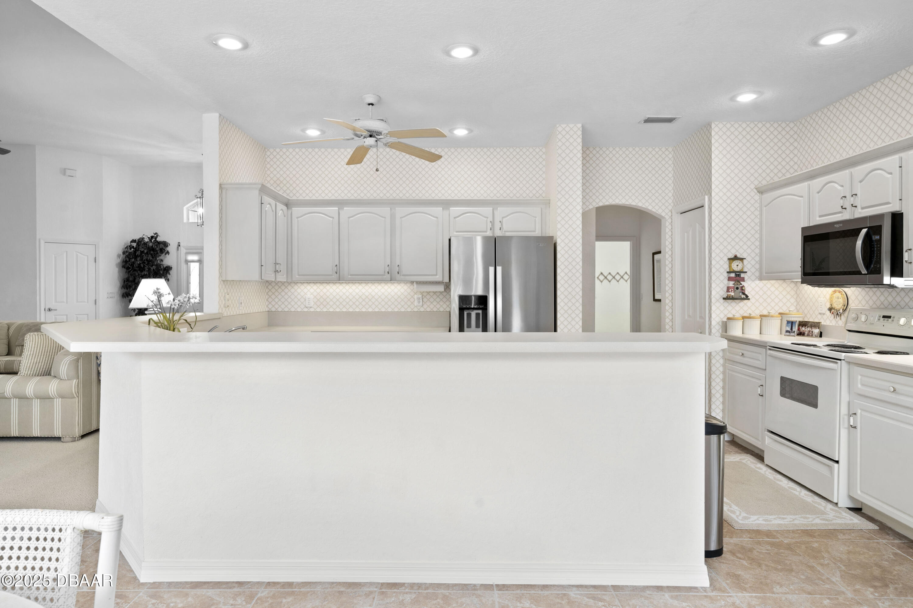 38 South Turn Circle Ponce Inlet, FL 32127 - Photo 10 of 49 a large white kitchen with kitchen island granite countertop lots of white stainless steel appliances and cabinets