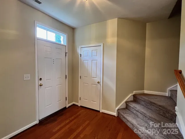 a view of a room with wooden floor