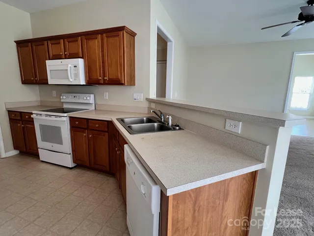 a white refrigerator freezer sitting inside of a kitchen