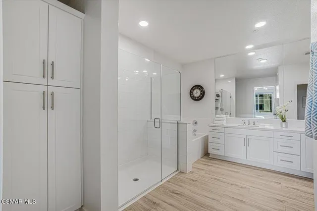 a living room with furniture a window and a potted plant