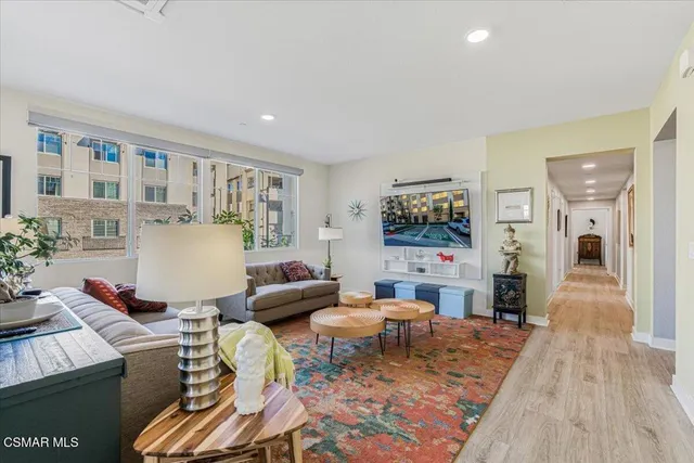 a dining room with furniture a window and wooden floor