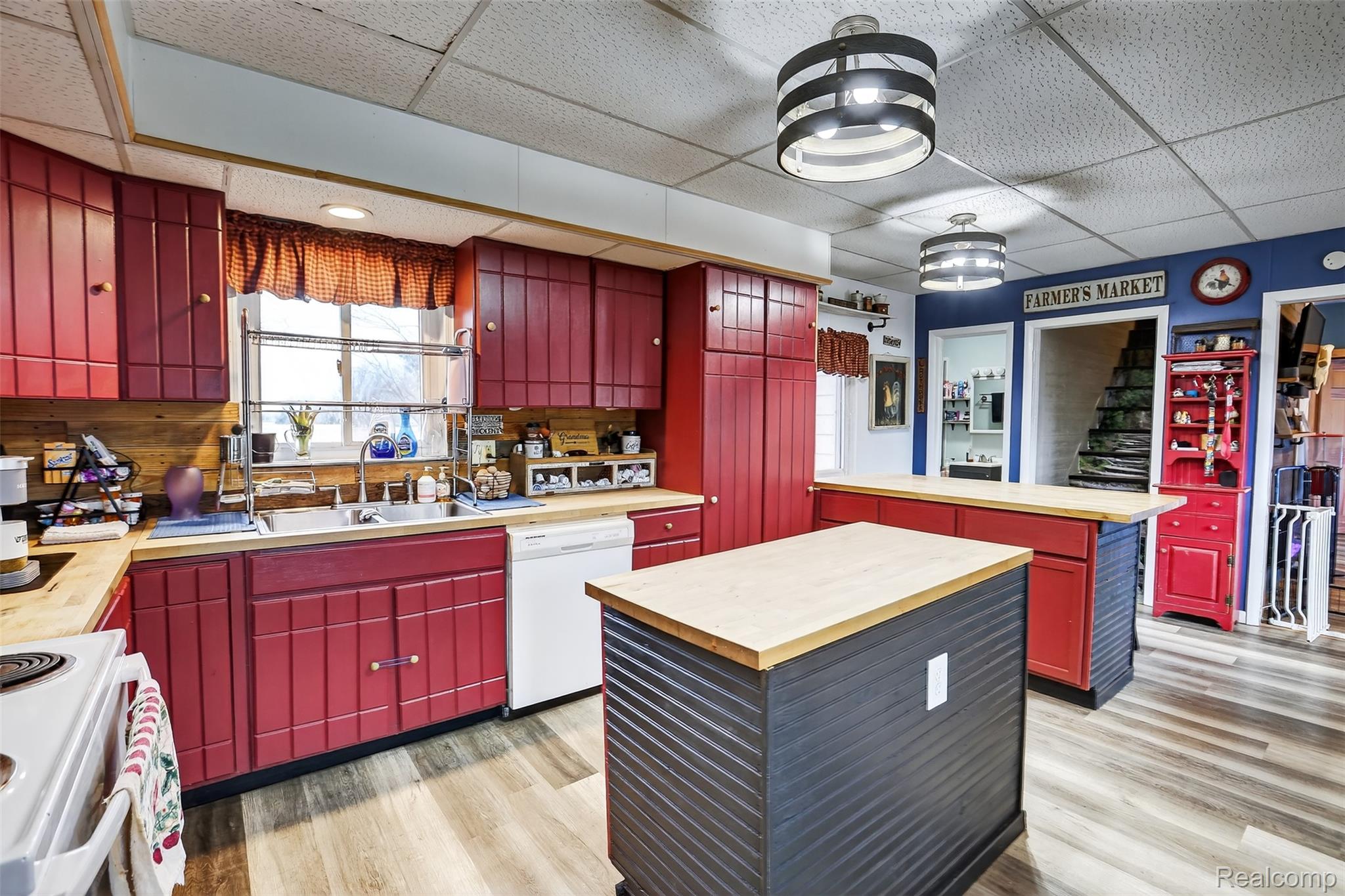 5639 Swaffer Road Millington, MI 48746 - Photo 5 of 25 Kitchen featuring red cabinetry, a center island, light wood-style floors, and a drop ceiling