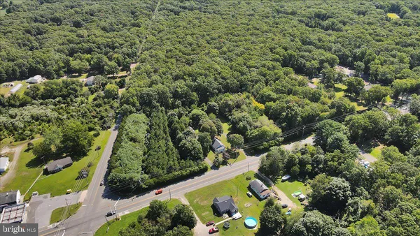 an aerial view of multiple houses with yard