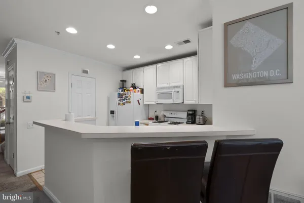 a kitchen with a sink cabinets and wooden floor