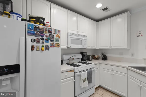 a kitchen with stainless steel appliances white cabinets and a sink
