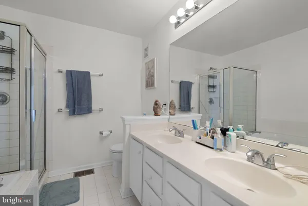 a bathroom with a sink double vanity and a toilet