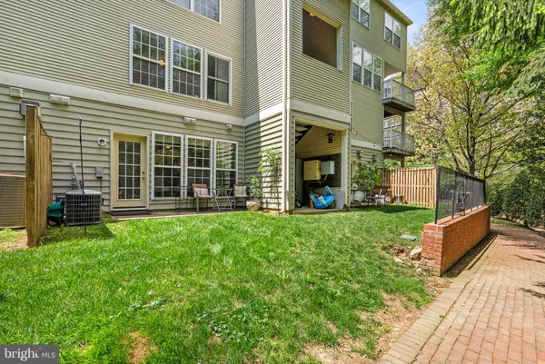 a view of a house with a yard and sitting area
