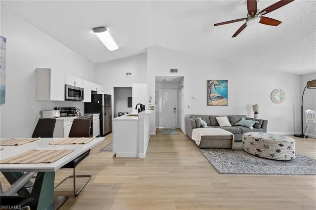 a living room with furniture and kitchen view