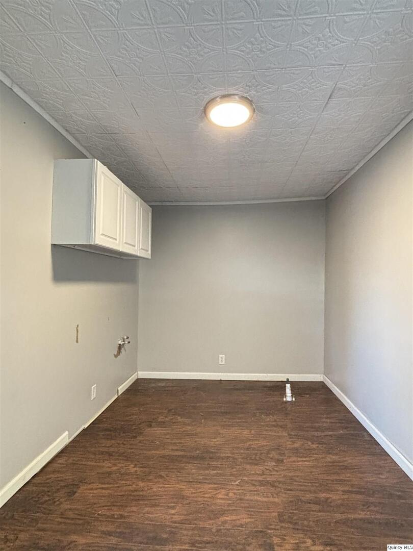 41 Main Street Carthage, IL 62321 - Photo 14 of 27 an empty room with wooden floor and windows