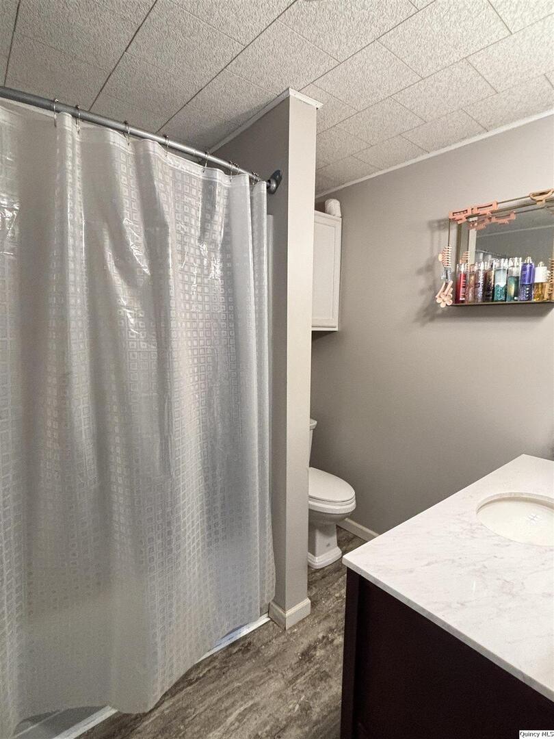 41 Main Street Carthage, IL 62321 - Photo 17 of 27 a bathroom with a shower curtain and sink