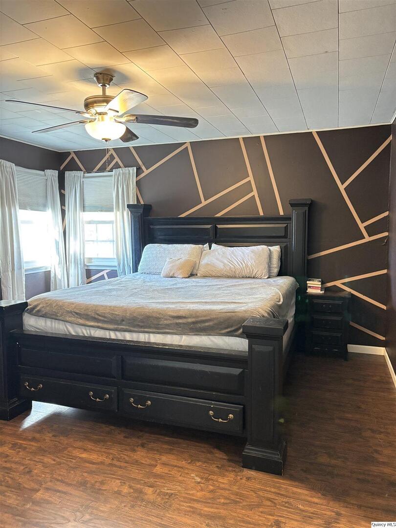 41 Main Street Carthage, IL 62321 - Photo 19 of 27 a bedroom with a bed a chandelier and closet