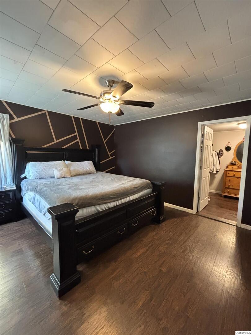 41 Main Street Carthage, IL 62321 - Photo 20 of 27 a bedroom with bed and wooden floor