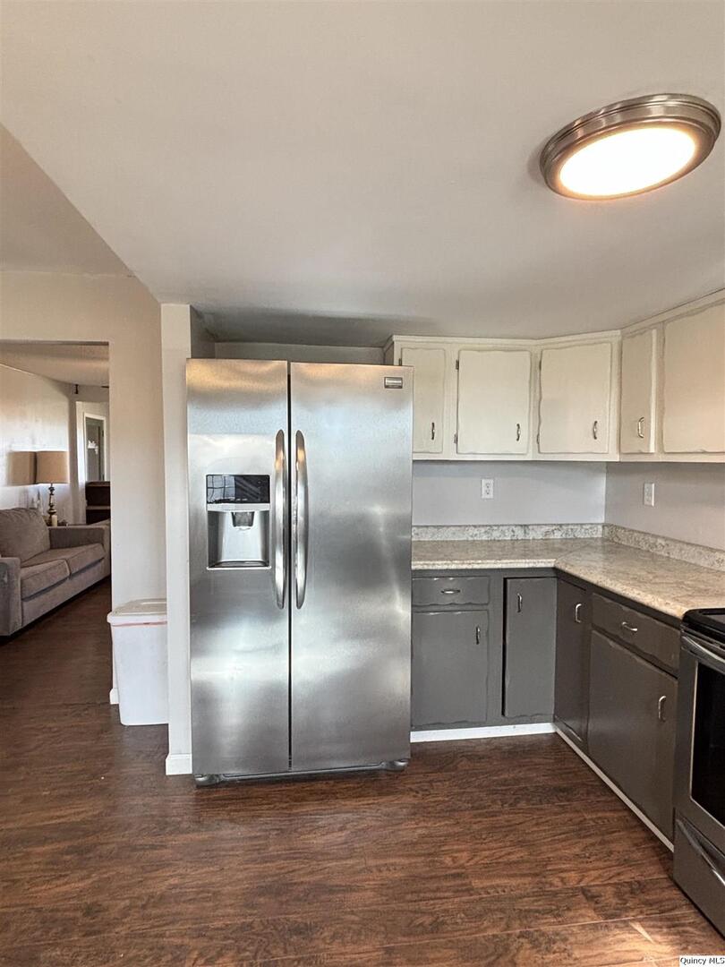 41 Main Street Carthage, IL 62321 - Photo 9 of 27 a kitchen with kitchen island a counter top space cabinets and stainless steel appliances