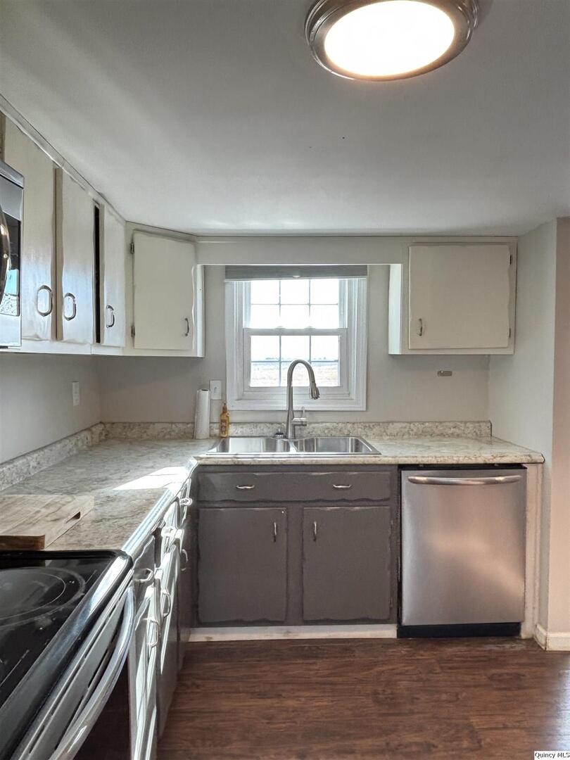 41 Main Street Carthage, IL 62321 - Photo 10 of 27 a kitchen with granite countertop a sink and a stove