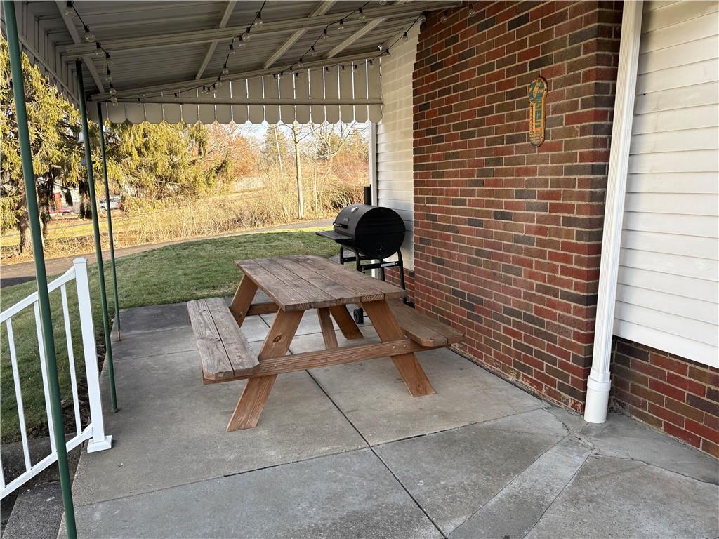 800 Tuscarawas Road Beaver, PA 15009 - Photo 20 of 26 a view of balcony with a table and chairs and floor to ceiling window with wooden fence