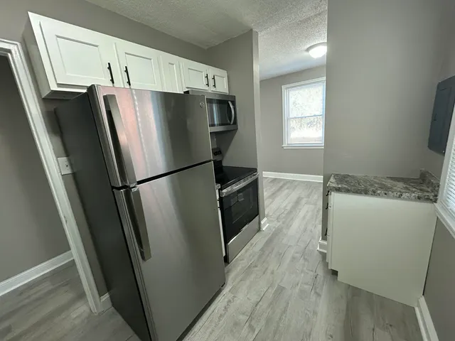 a refrigerator freezer sitting inside of a kitchen