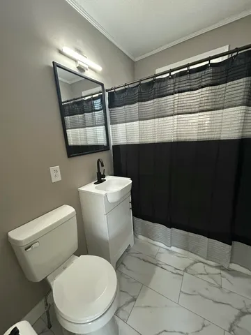 a bathroom with a toilet a sink and shower