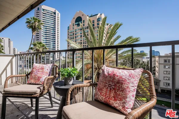 a balcony with furniture and a potted plant