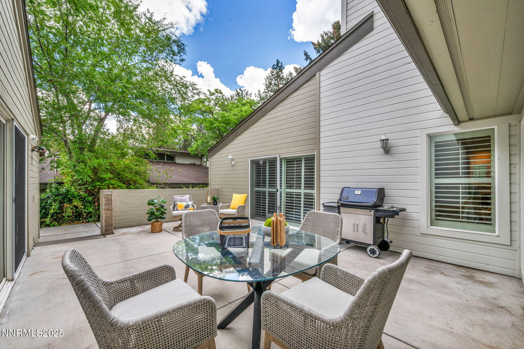 a backyard of a house with outdoor seating