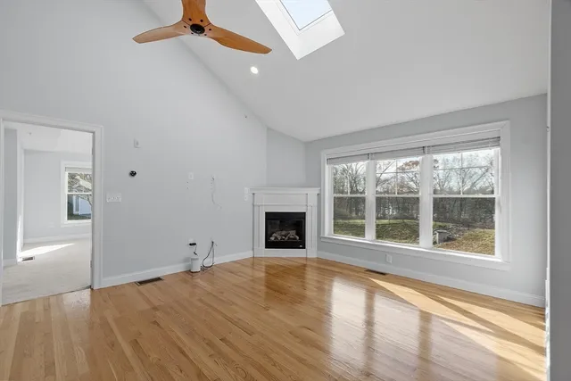 a view of an empty room with window and fire place