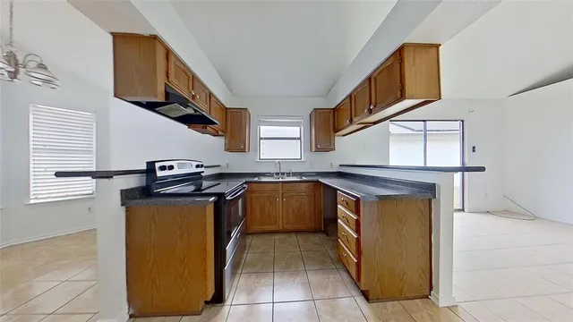 a kitchen with stainless steel appliances granite countertop a stove and a refrigerator