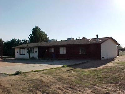15550 Erie Road, Unit 2 Apple Valley, CA 92307 - Photo 1 of 1 a house that has tree in front of it