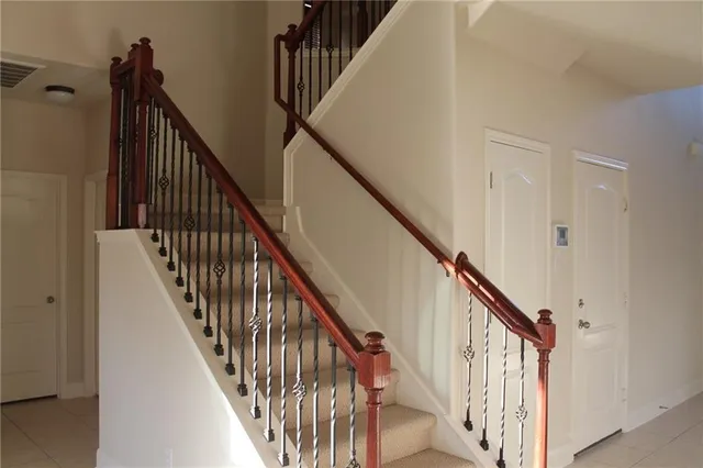 a view of staircase with railing and a window