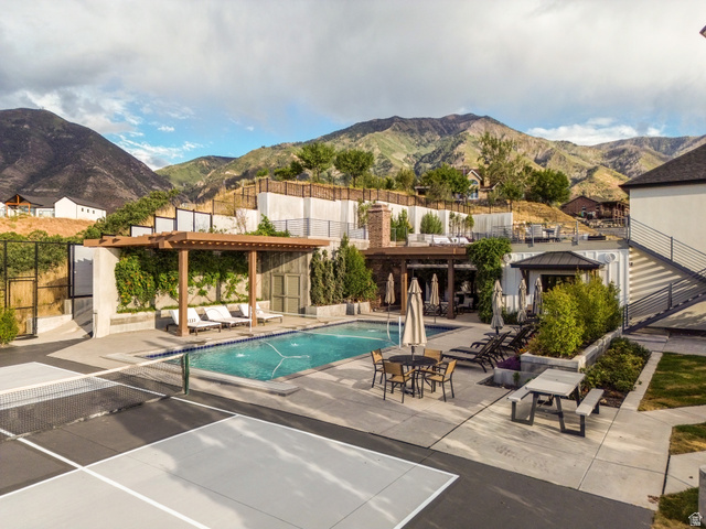 912 North Loafer Canyon Road Elk Ridge, UT 84651 - Photo 94 of 98 Outdoor swimming pool with integrated spa and lounge area, adjacent to a hard surface sports court