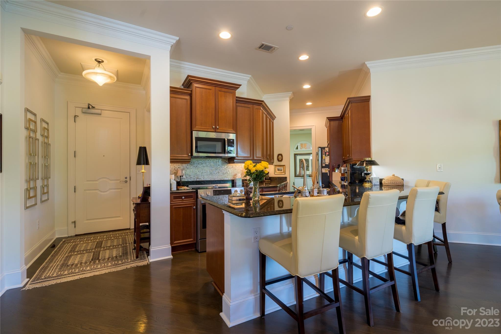 626 Queens Road, Unit 303 Charlotte, NC 28207 - Photo 13 of 41 a kitchen with a table and chairs in it