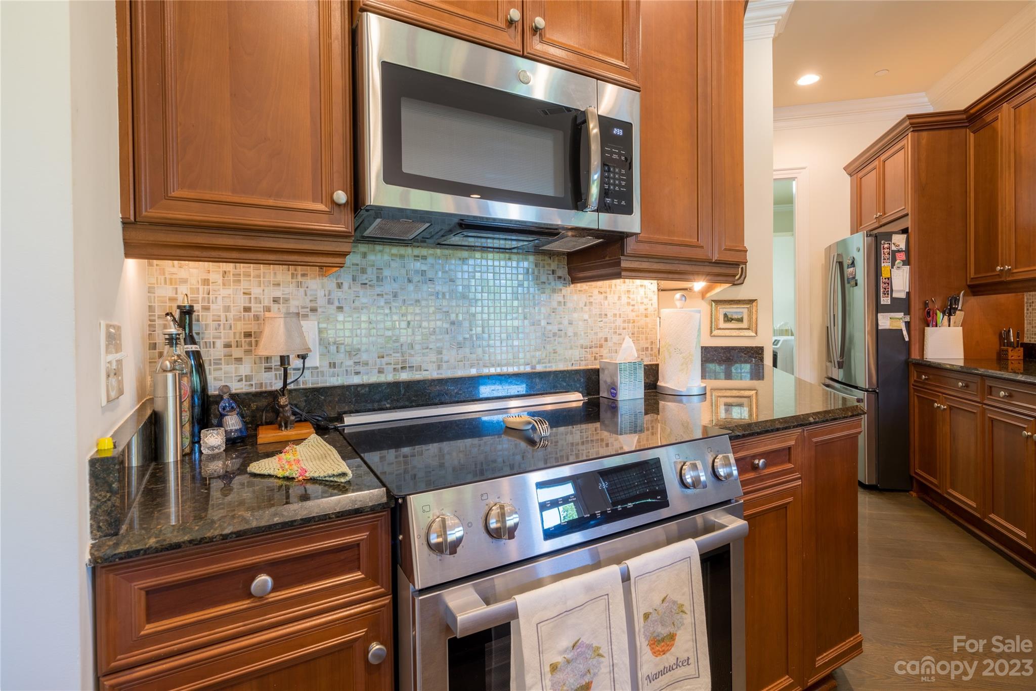 626 Queens Road, Unit 303 Charlotte, NC 28207 - Photo 19 of 41 a kitchen with stainless steel appliances granite countertop a stove and a microwave