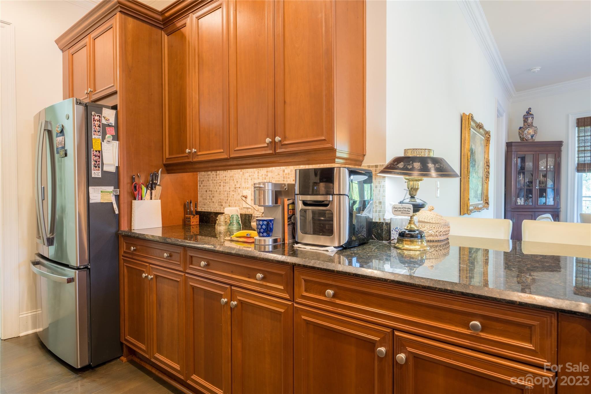 626 Queens Road, Unit 303 Charlotte, NC 28207 - Photo 21 of 41 a kitchen with stainless steel appliances granite countertop a refrigerator and cabinets