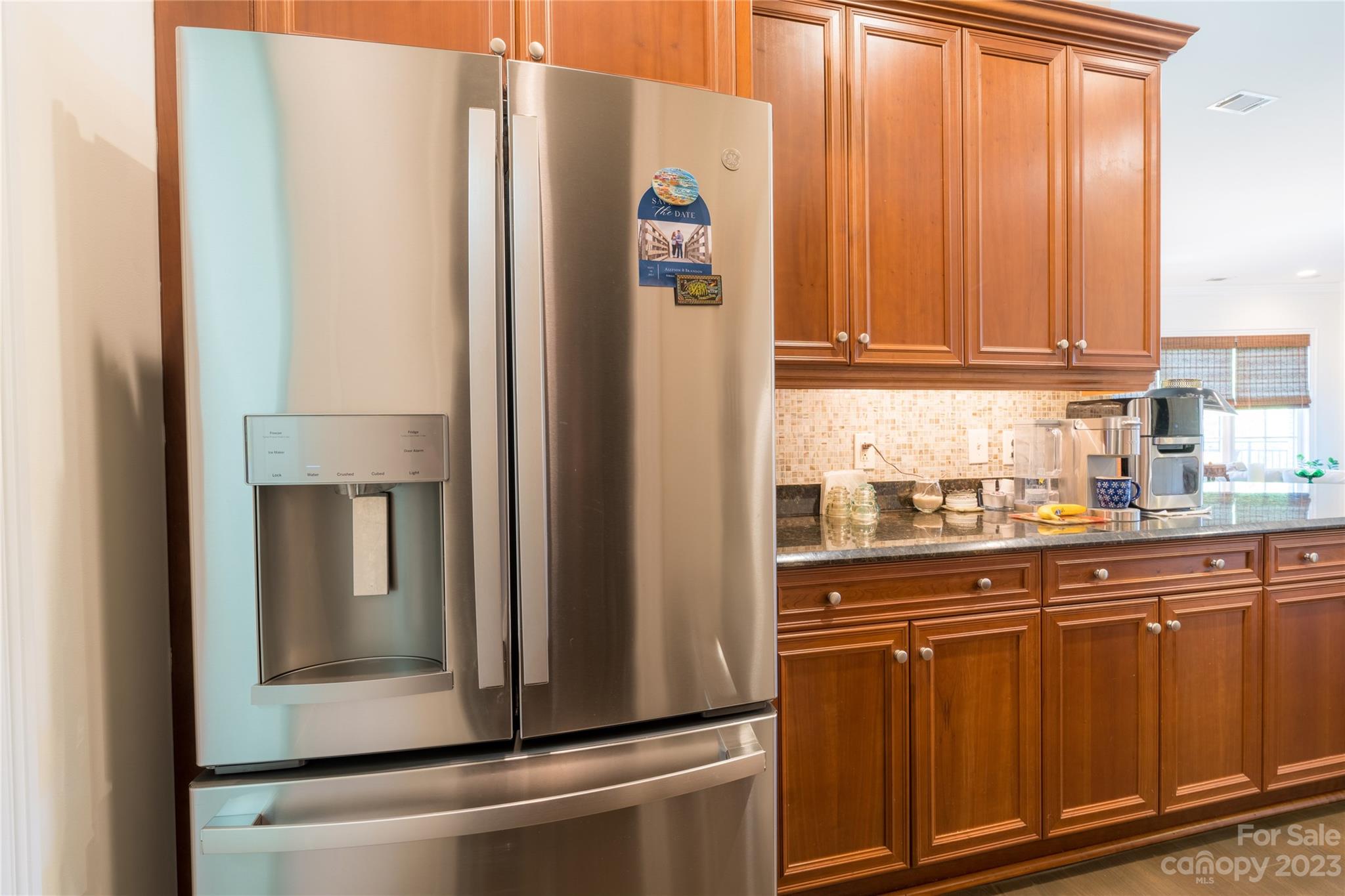 626 Queens Road, Unit 303 Charlotte, NC 28207 - Photo 22 of 41 a kitchen with metallic refrigerator and cabinet