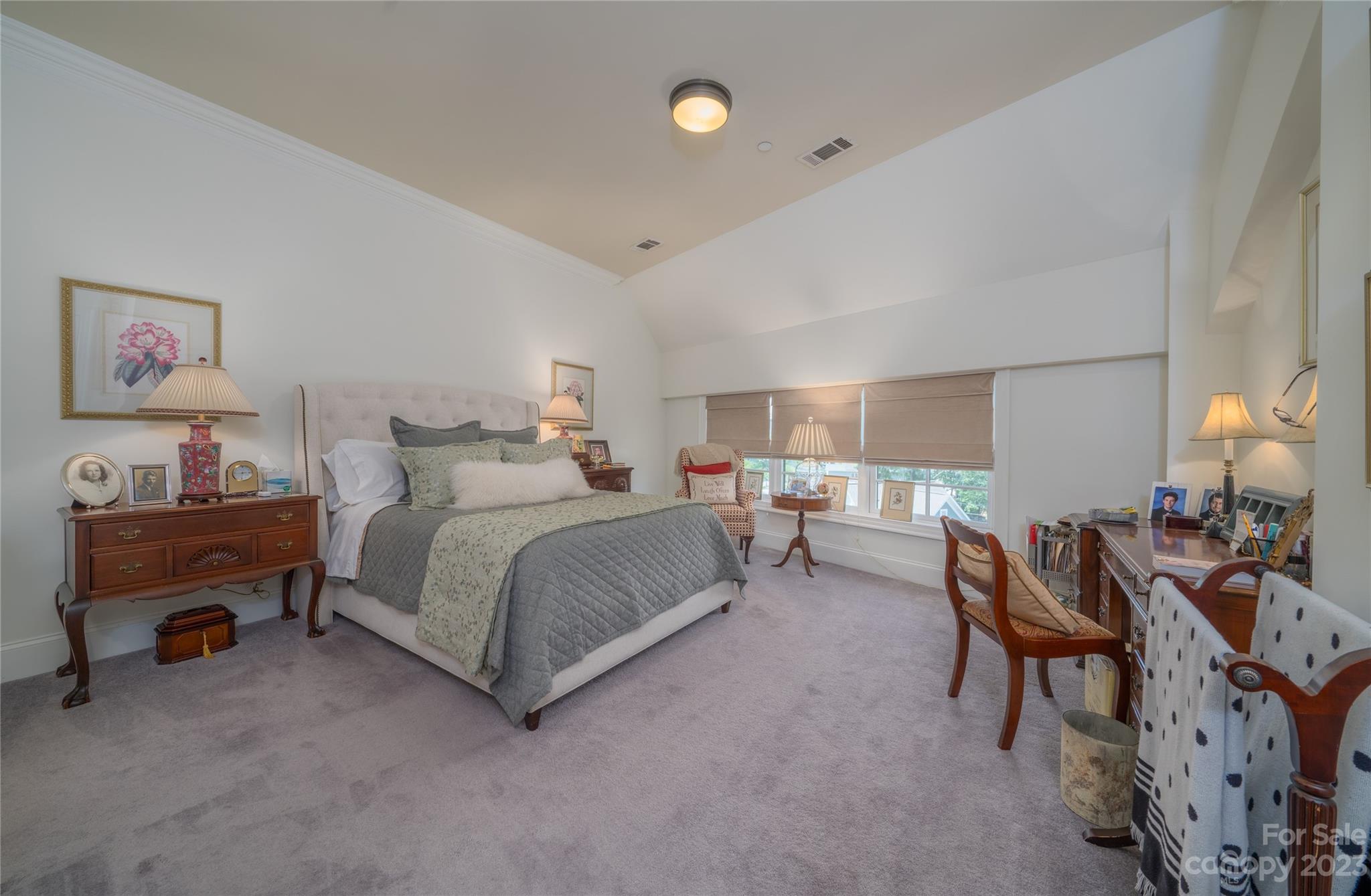 626 Queens Road, Unit 303 Charlotte, NC 28207 - Photo 28 of 41 a bedroom with a bed and a lamp on table