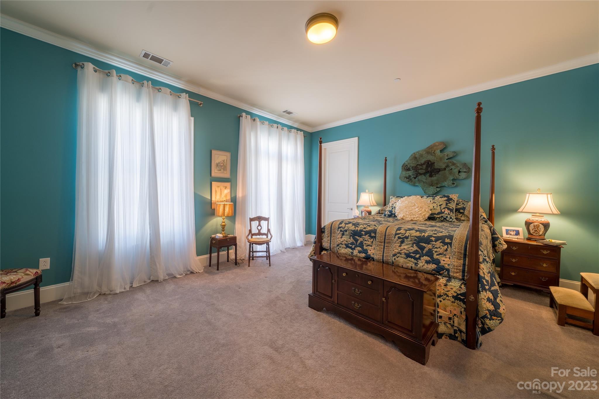 626 Queens Road, Unit 303 Charlotte, NC 28207 - Photo 33 of 41 a bed sitting in a spacious bedroom next to a window and a larger closet