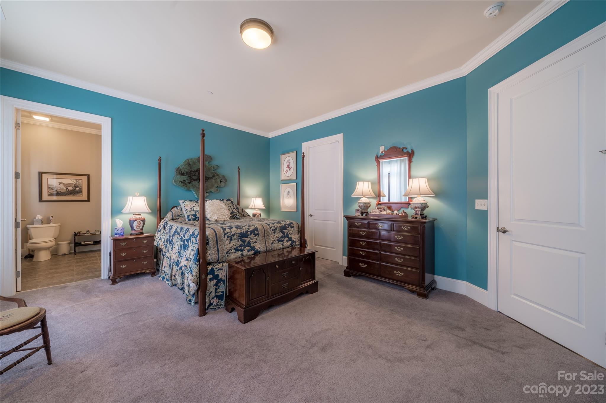 626 Queens Road, Unit 303 Charlotte, NC 28207 - Photo 34 of 41 a spacious bedroom with a bed and a chair