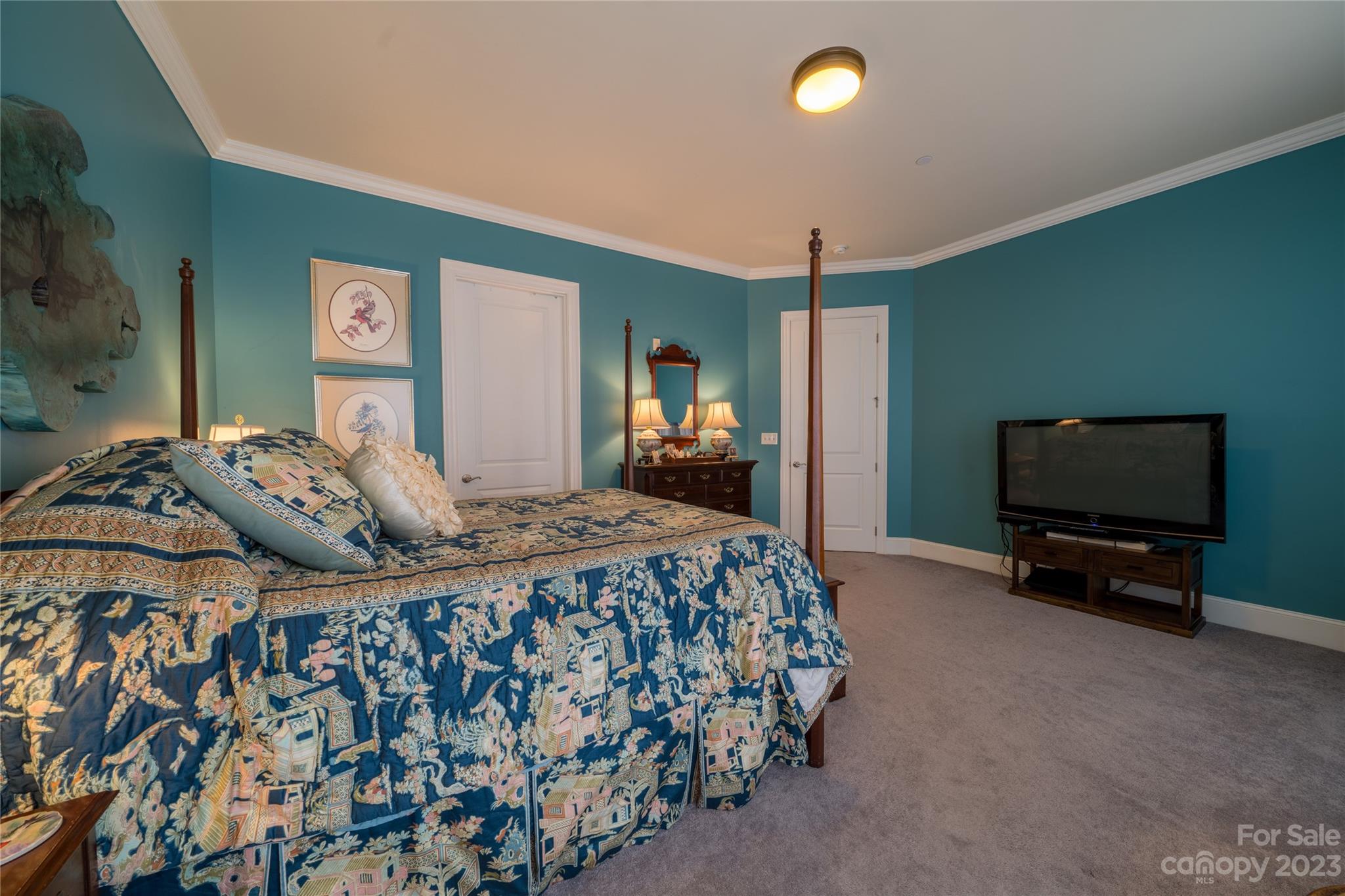 626 Queens Road, Unit 303 Charlotte, NC 28207 - Photo 35 of 41 a bedroom with a bed and a flat tv screen on dresser