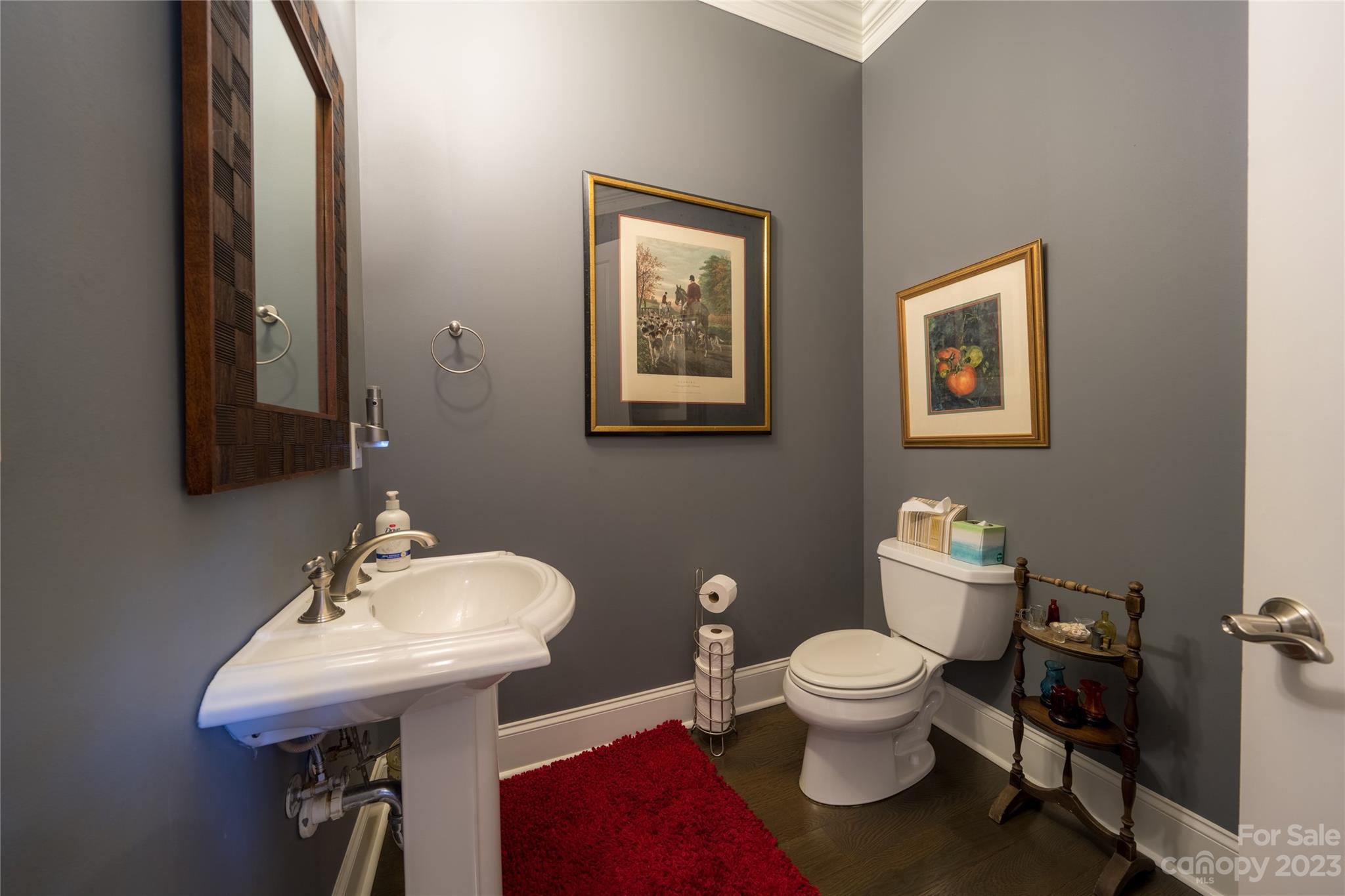 626 Queens Road, Unit 303 Charlotte, NC 28207 - Photo 40 of 41 a bathroom with a toilet a sink and a mirror