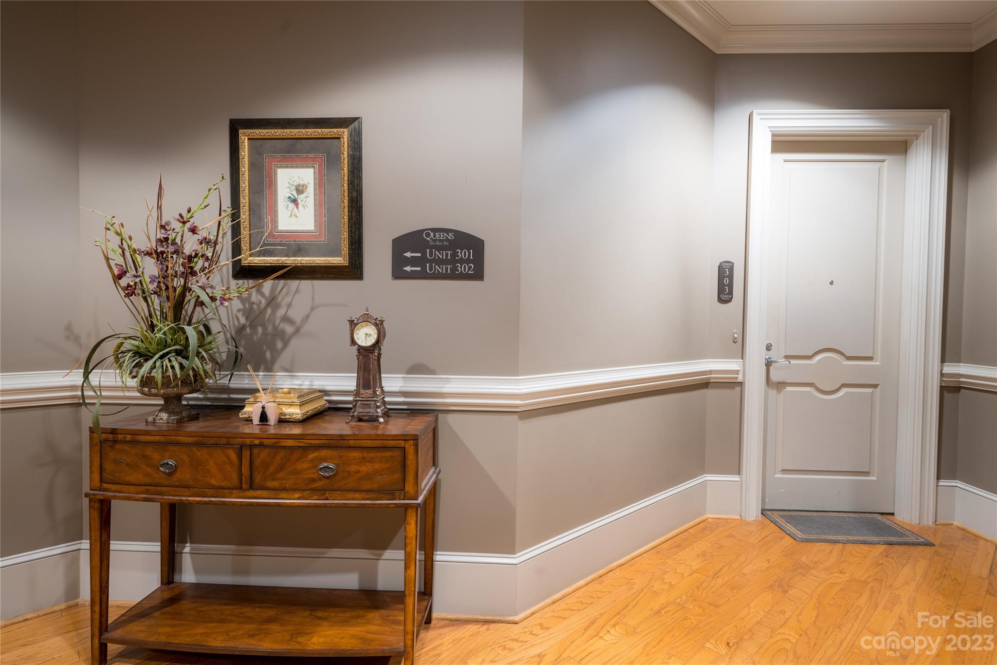 626 Queens Road, Unit 303 Charlotte, NC 28207 - Photo 10 of 41 a view of a room with rack on the wall and a potted plant