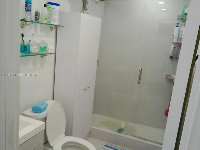 a bathroom with a shower and toilet