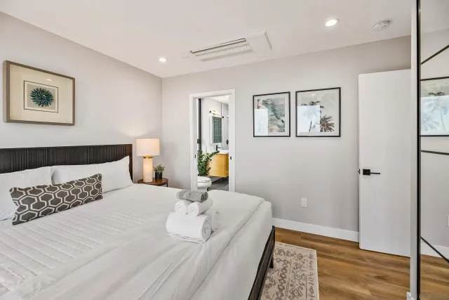 a bedroom with a large bed and a window