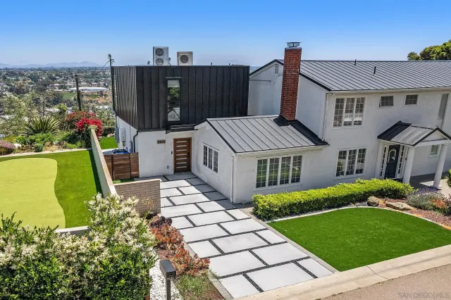 an aerial view of a house with swimming pool garden and patio