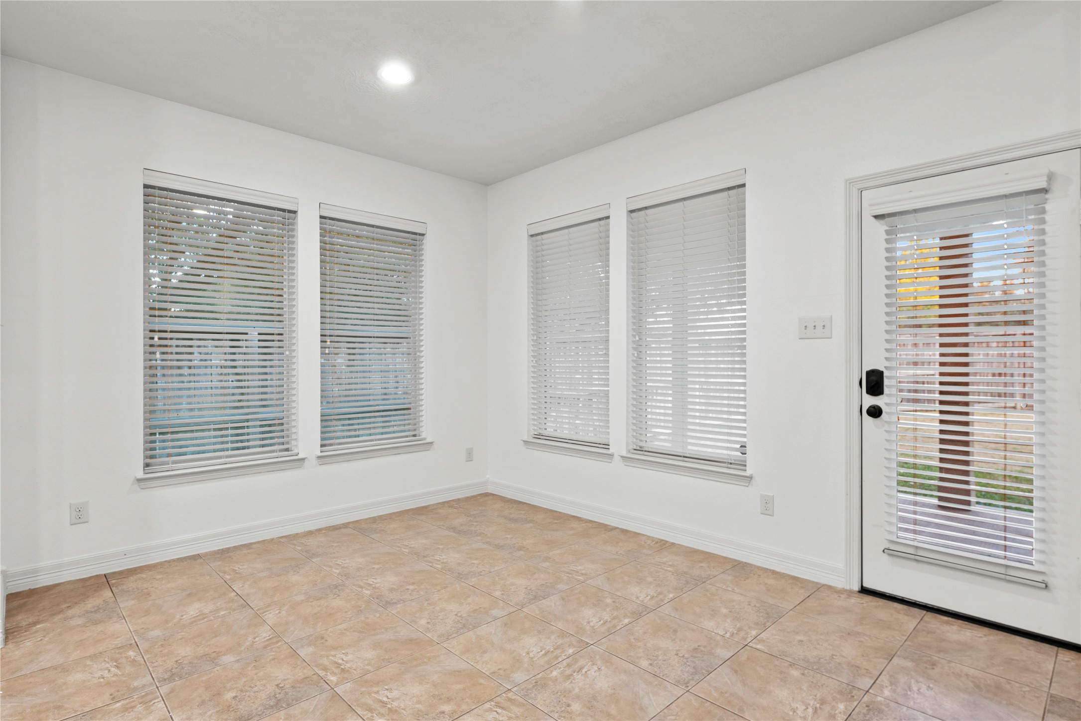 5827 Amherst Farms Lane Fulshear, TX 77441 - Photo 16 of 48 The oversized breakfast area seamlessly connects the kitchen and family room, creating an ideal flow for everyday living and entertaining. Large windows fill the space with natural light, while a door provides direct access to the backyard patio.