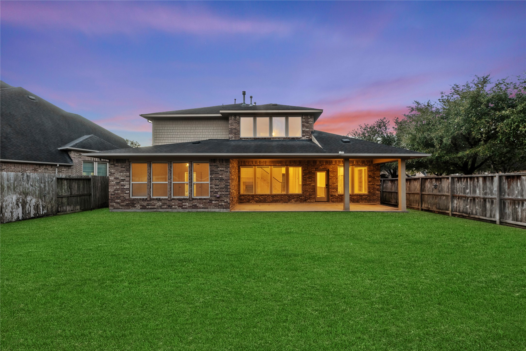 5827 Amherst Farms Lane Fulshear, TX 77441 - Photo 31 of 48 The lush, fully fenced backyard features an expansive lawn, creating a private setting ideal for entertaining, pets, or future outdoor enhancements.