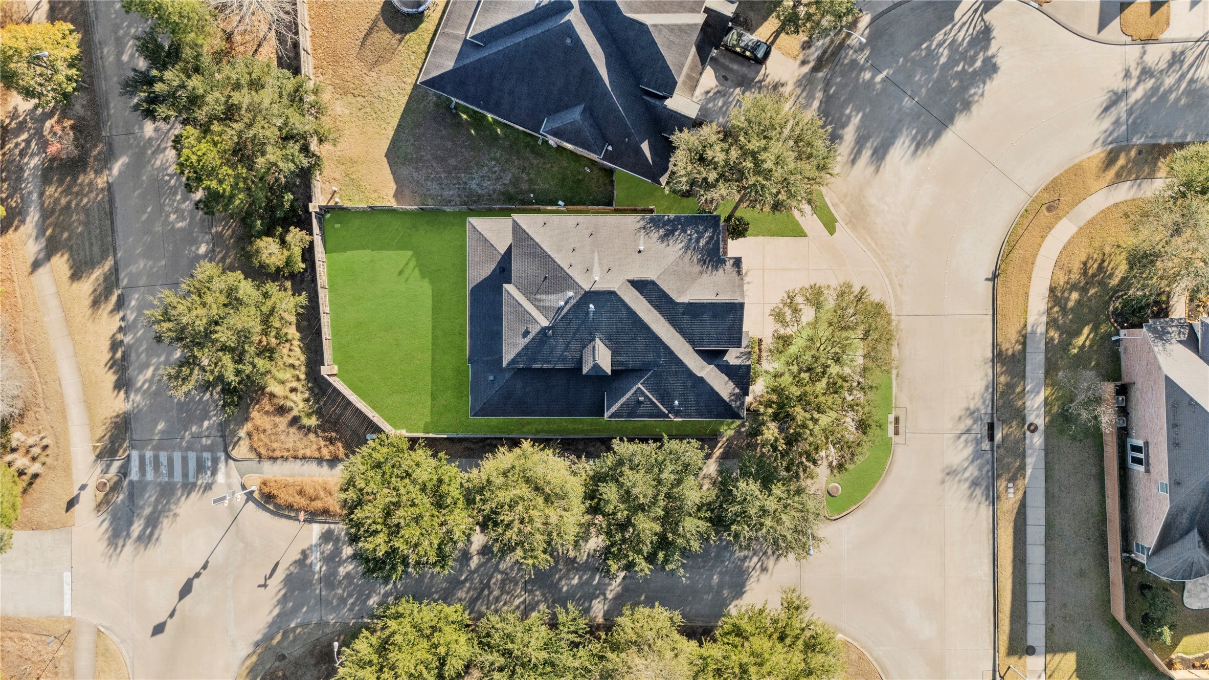 5827 Amherst Farms Lane Fulshear, TX 77441 - Photo 39 of 48 Overhead drone view highlights the home’s spacious layout, extended driveway, and fully fenced backyard. The lot’s positioning provides separation from neighboring homes while maximizing yard space.